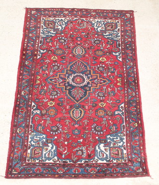 A Persian Behbahan red ground rug with central medallion 81" x 54" 