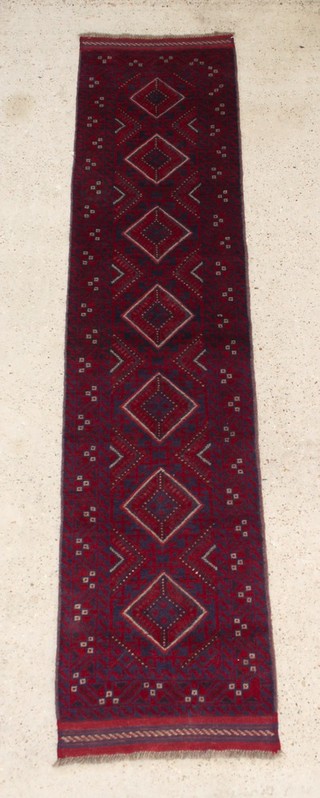 A contemporary red and blue ground Meshwani runner with 7 diamonds to the centre 102" x 23" 