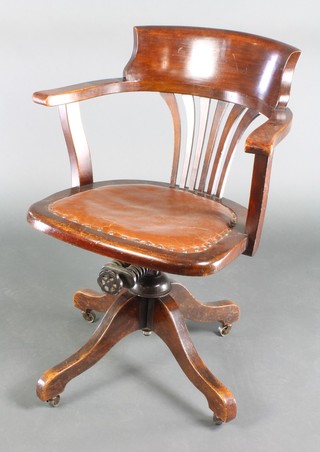 An Edwardian mahogany tub back revolving office chair 