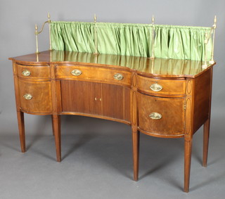A Regency mahogany shaped sideboard with raised brass rail to the back, fitted 1 long drawer above a cupboard enclosed by a tambour shutter flanked by 2 short drawers above 1 short drawer and cupboard 55"h x 73"w x 29"d 
