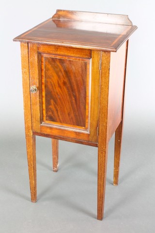 An Edwardian inlaid mahogany bedside cabinet with raised back, inlaid satinwood stringing with cupboard enclosed by a panelled door, raised on square tapered supports 32 1/2"h x 16"w x 14"d 