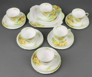 A Shelley tea set decorated with daffodils 13670 comprising 6 tea cups, 6 saucers, milk jug, sugar bowl, 6 small plates and a sandwich plate 

