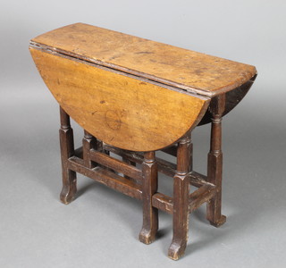 An 18th Century oak oval drop flap gateleg tea table, raised on turned supports 28"h x 36"w x 10 1/2" when closed by 35" when extended