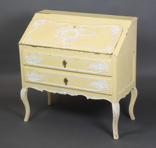 A 19th Century French cream and white painted carved oak bureau, the fall front revealing a stepped interior above 2 long drawers, raised on carved cabriole supports 34"h x 34"w x 16 1/2"d 
