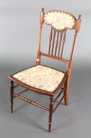 An Edwardian Art Nouveau inlaid mahogany stick and rail back bedroom chair with upholstered seat, raised on turned supports  