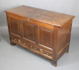 An 18th Century oak mule chest of panelled construction with hinged lid and iron butterfly hinges, the interior fitted a candle box, the base fitted 2 drawers with brass ring drop handles, the apron carved SM 32"h x 51"w x 21"d  
