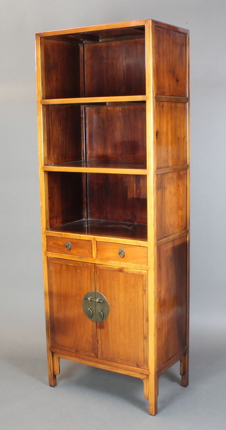 A Chinese hardwood cabinet, the upper section with 3 recesses above 2 short drawers, the base enclosed by a panelled door 73"h x 26"w x 15 1/2"d 