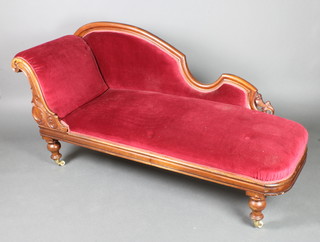 A Victorian carved mahogany show frame chaise longue upholstered in red Dralon, raised on turned supports 34 1/2"h x 72"w x 23"w 
