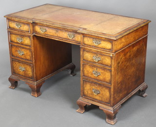 A Queen Anne style figured walnut inverted breakfront kneehole desk with brown leather writing surface above 1 long and 8 short drawers, raised on ogee bracket feet 28 1/2"h x 47"w x 24"d 