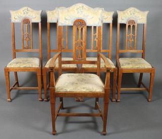 A set of 5 Art Nouveau "Glasgow School" dining chairs, 1 carver and 4 standard, with pierced slat backs and upholstered drop in seats on square tapering set with H framed 