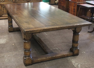 An oak refectory style dining table with 2 side extensions, the top formed of 3 planks, the apron with carved decoration raised on turned and block supports with H framed stretcher 31"h x 48"w x 96"l x 132"l with the extensions