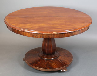 A Victorian circular mahogany snap top breakfast table, raised on a chamfered column and circular base with bun feet 31"h x 50" diam. 