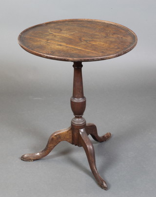 An 18th Century circular oak dish top wine table raised on pillar and tripod base 27"h x 22" diam. 