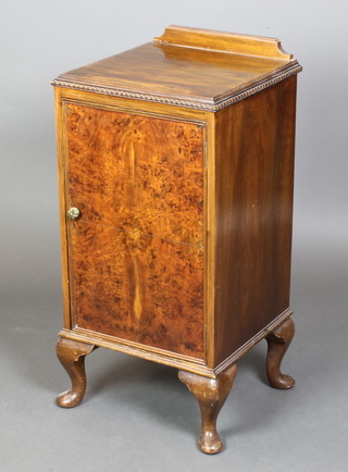 A Queen Anne style figured walnut bedside cabinet with raised back, enclosed by a quarter veneered panelled door, raised on bracket feet 32"h x 15"w x 15"d 