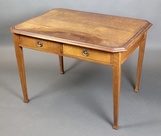 An Art Nouveau oak lozenge shaped library table with planked top fitted 2 frieze drawers, raised on square tapering supports 29"h x 42 1/2"w x 31 1/2"d 