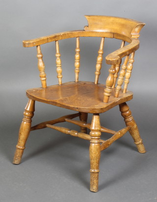 A Victorian elm smoker's bow chair with solid seat, raised on turned supports with H framed stretcher