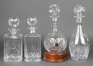 A cut crystal mallet decanter and stopper on a shaped base 10", 3 other decanters