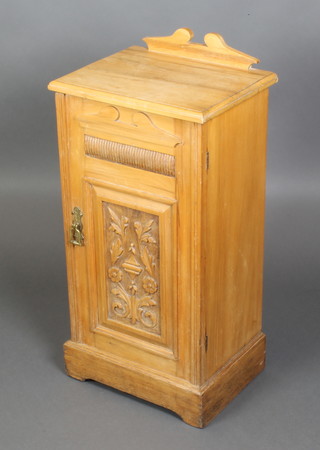 A Victorian carved satinwood pot cupboard with raised back, enclosed by a panelled door, raised on a platform base 32"h x 15" x 12" 