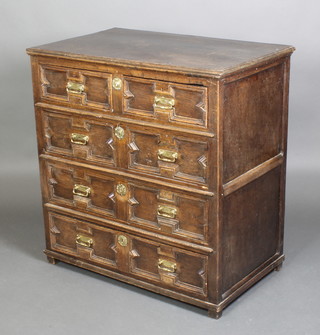 A Jacobean oak chest with geometric mouldings and brass drop handles, fitted 2 short drawers above 3 long drawers 
