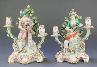 A pair of 19th Century Samson 2 light candlesticks in the form of a seated gentleman and dog and a seated lady with musical instrument and lamb 13"  
