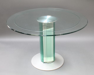 A circular plate glass dining table, raised on a square faceted mirrored glass and chrome base, 30"h x 47" diam. 
