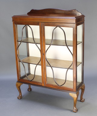A 1930's mahogany display cabinet with raised back, fitted shelves enclosed by astragal glazed doors, raised on cabriole supports 50"h x 35"w x 12"d 