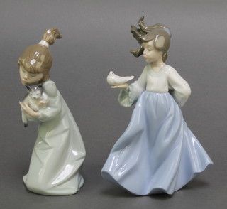 A Lladro figure of a kneeling girl with kitten 5712 7", a Nao figure of a girl with dove 7" 