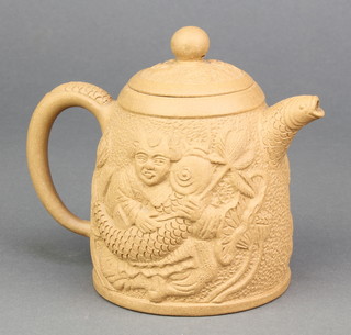 A pale Tan ware teapot decorated with a figure holding a giant fish, having a fish spout and character mark to base and a lid 4 3/4" 
