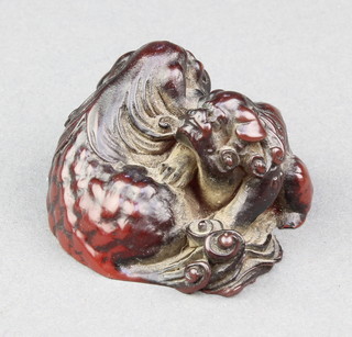 A resin Netsuke in the form of  2 reclining Shi Shi, signed 1 3/4" 