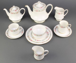 A Paragon and Royal Albert Belinda pattern part tea and coffee service comprising 25 tea cups, 10 coffee cups, 39 saucers, a breakfast teapot, 2 large tea pots, a cream jug, a milk jug and 2 sugar bowls, 36 sandwich plates, 4 medium plates and 2 cake stand tiers 