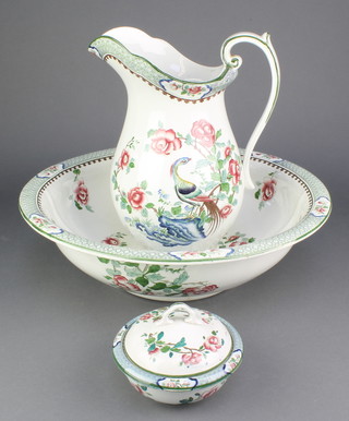 A Corona Ware wash jug, basin and soap dish decorated with birds amongst flowers 