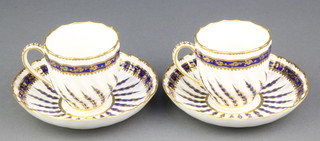 A pair of 19th Century Derby teacups and saucers with blue and gilt spiral decoration 