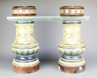 A pair of Doulton Lambeth baluster balustrades with tops decorated with stylised leaves and motifs 17 1/2"  