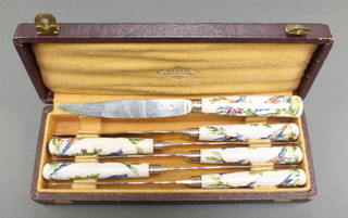 Six 19th Century French silver bladed dessert knives with porcelain handles depicting exotic birds, cased 