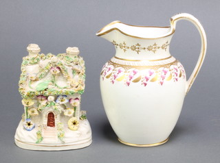 A 19th Century milk jug with gilt and ochre decoration 5" and a 19th Century Staffordshire cottage 4 1/2" 
