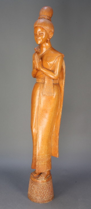 A "Burmese" carved hardwood figure of a standing lady at prayer 48"h 