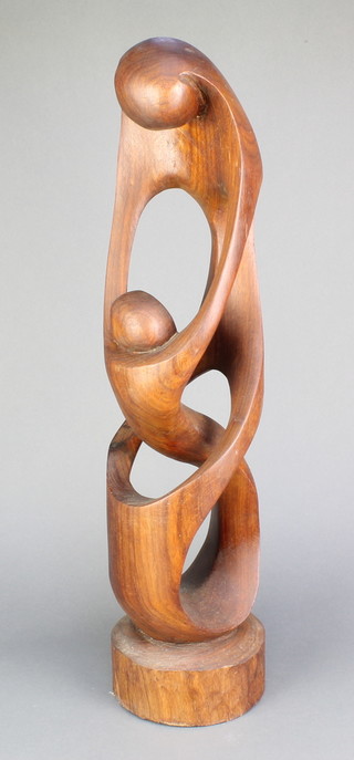After Henry Moore, a carved teak sculpture of a mother embracing a child 23" 