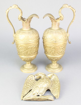 A pair of Victorian bronze ewers with relief decoration depicting classical figures 12" and an embossed brass plaque in the form of an eagle 6" 