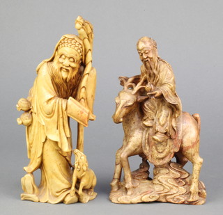 A carved soapstone figure of a standing deity with dog 8" and 1 other carved soapstone figure 7" 