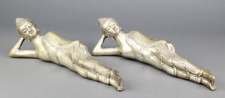 A pair of polished white metal figures of reclining Buddhas 12" 