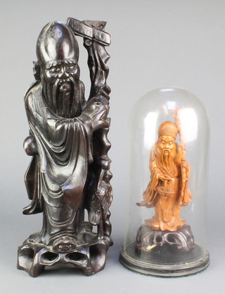 A Japanese carved hardwood figure of a Deity 16" and a ditto figure carrying a basket on a hardwood stand complete with dome 9" 