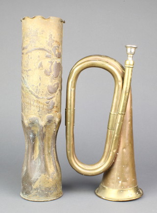 A copper and brass bugle together with a WW1 trench art vase formed from an 18lb shell