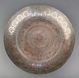 A circular Eastern engraved dish the centre engraved a figure of a "crusader" with severed head 11" x 1 1/2" 