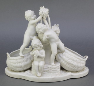 A Continental bisque figure group of 3 cavorting cherubs with baskets and grapes 10 1/2" 