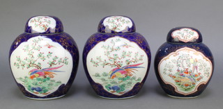 A pair of late Samson blue ground ginger jars and covers with panels of exotic birds amongst flowers 9" and a smaller ditto 7"