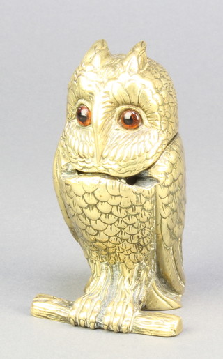 A Victorian inkwell in the form of a seated owl complete with pottery liner and inset glass eyes 4" 