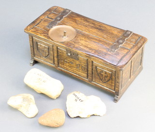A miniature oak coffer with hinged lid containing a collection of various stones found at the site of the Battle of Naseby 3 1/2"h x 9"w x 4"d  