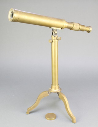A brass 1 draw telescope, raised on a tripod 
