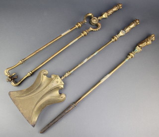 A set of 3 brass fireside implements, the handles decorated rampant lions - tongs, poker and shovel 