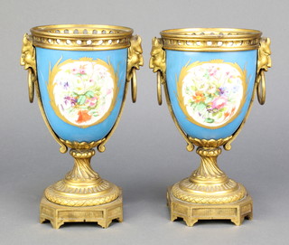 A pair of "Sevres" and gilt ormolu mounted twin handled urns with devil mask handles 8" 